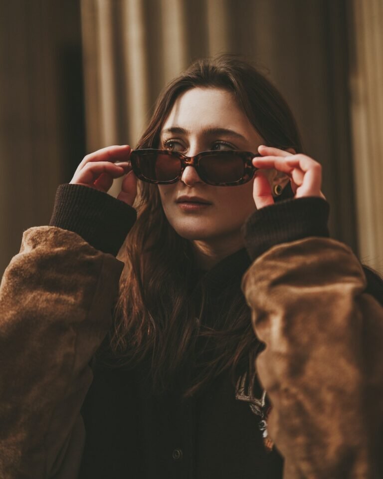 Young Woman Looking Over Sunglasses on Face