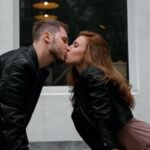 Kissing Couple Wearing Black Jackets