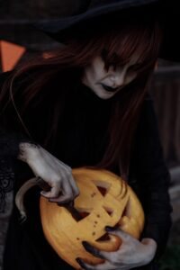 Witch Carving a Pumpkin